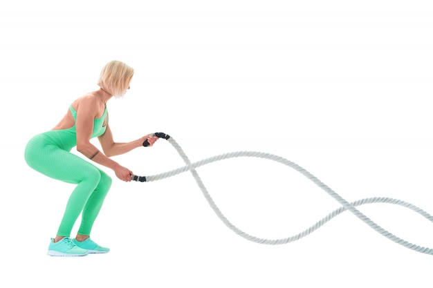 Woman doing exercises with battle rope