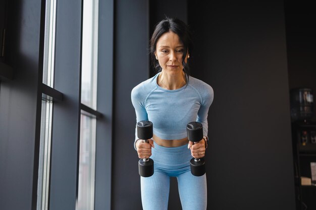 Woman doing exercises with dumbbells