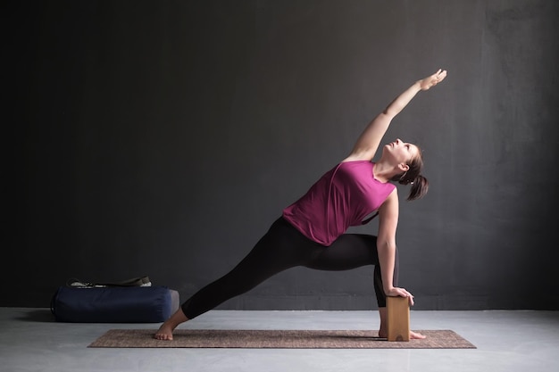 Woman doing Extended Side Angle posture Utthita Parsva Konasana