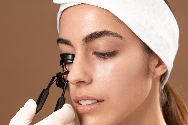 Woman doing an eyelashes treatment to her client