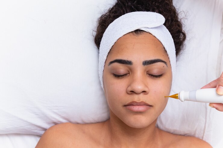 Woman doing facial treatment with plasma jet in beauty clinic.
