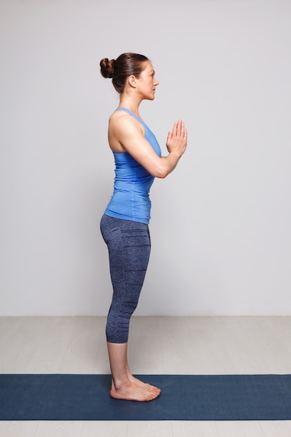 woman doing hatha yoga asana tadasana