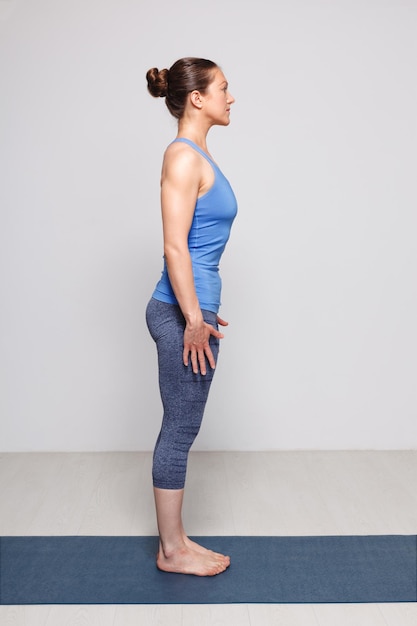 woman doing hatha yoga asana tadasana