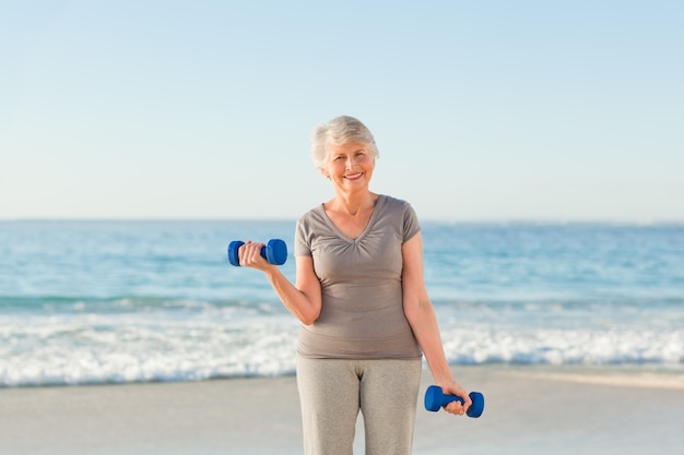 Woman doing her exercises at the beach