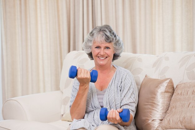 Woman doing her exercises on her sofa