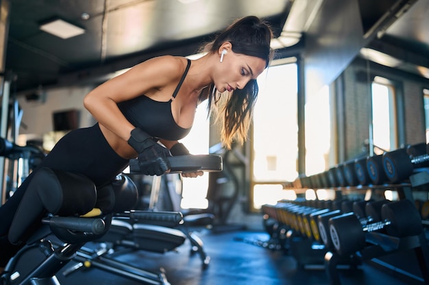 Woman doing hyperextension with weight