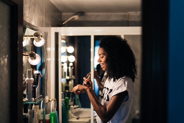 Woman doing makeup at home