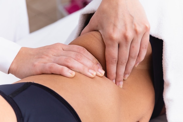 Woman doing modeling massage at the clinic