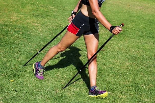 A woman doing nordic walking in the park