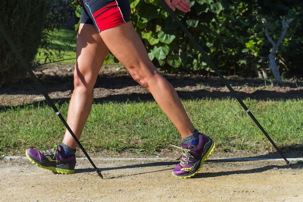 A woman doing nordic walking in the park