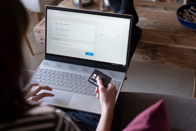 Woman doing online shopping using laptop