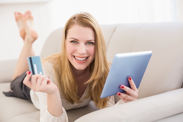 Woman doing online shopping with tablet and credit card