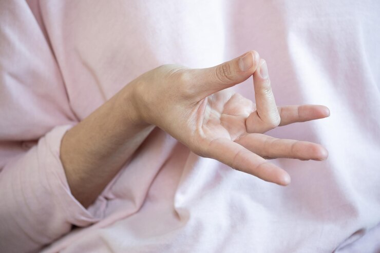 Woman doing Prithvi mudra with her hand