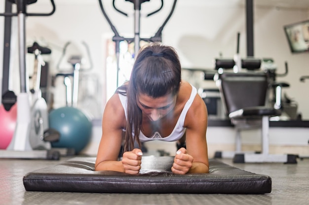 Woman doing push-ups in gym