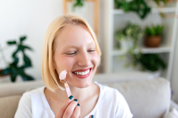 Woman doing self massage with rose quartz face roller