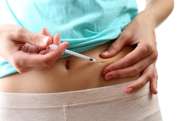 Woman doing shot in stomach close up