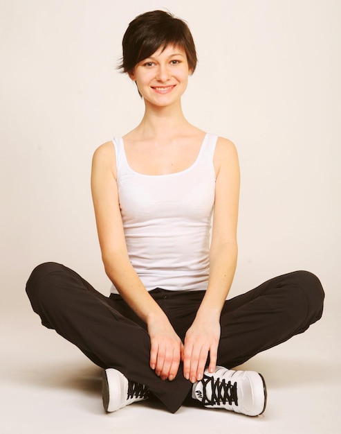 Woman doing stretching exercise at the gym