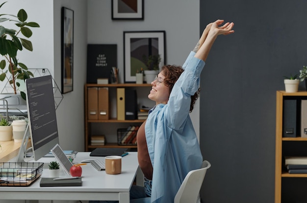 Woman doing stretching exercises at her workplace