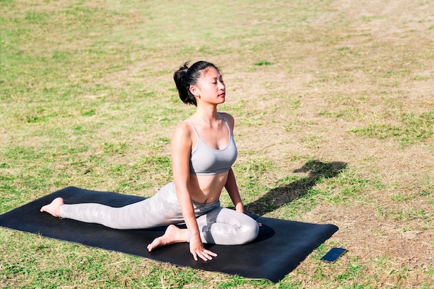 Woman doing stretching exercises using the phone