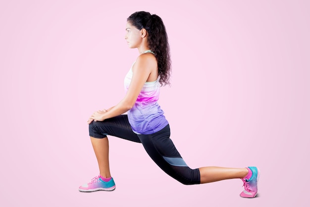 Woman doing warmup before exercising in studio