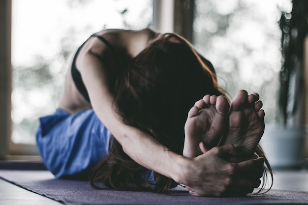 woman doing yoga on floor at home