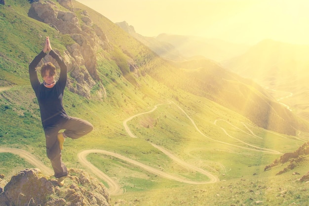 Woman doing yoga in the mountains