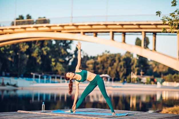 Woman doing yoga outdoors in the summer