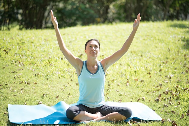 Foto donna che fa yoga al parco