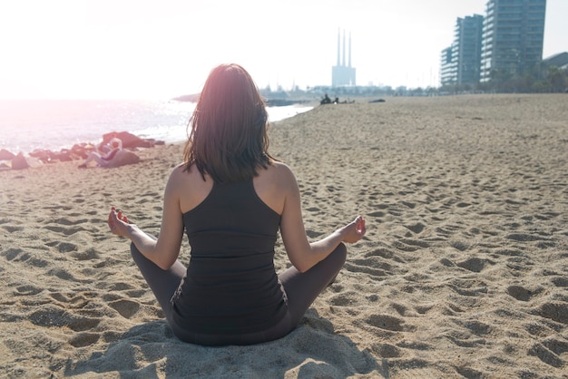 woman doing yoga at the sea