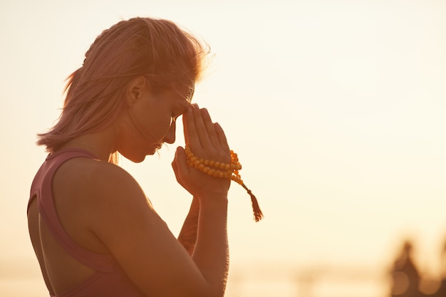 Woman doing yoga during sunset