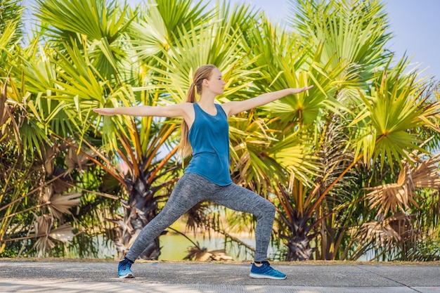 Woman doing yoga in a tropical park