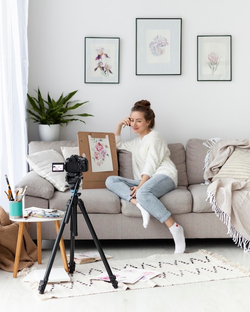 Woman drawing for an online tutorial indoors