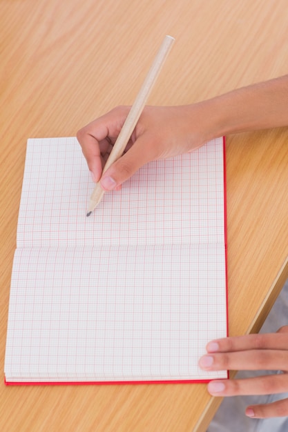 Woman drawing on a paper with a pencil