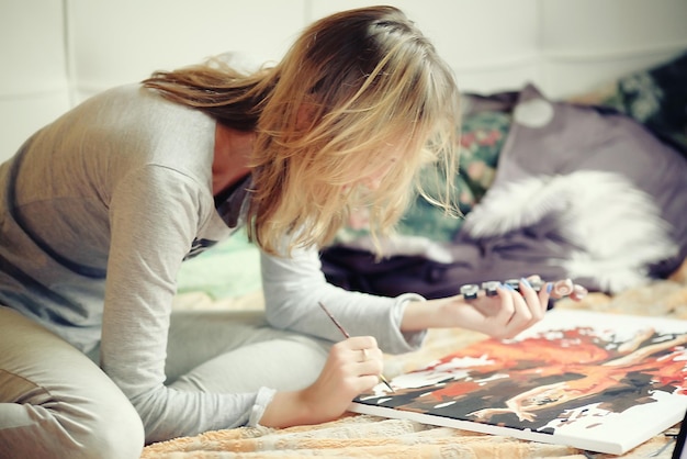 woman draws at home