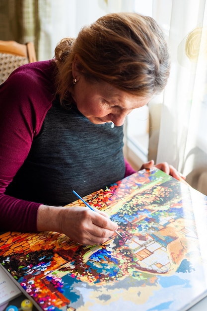 Woman draws with a brush painting by numbers on canvas Picture by numbers Drawing on canvas