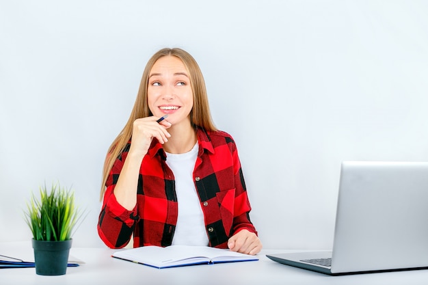 Woman dreaming with a laptop at home or office