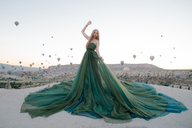 Woman in dress among balloons in cappadocia 