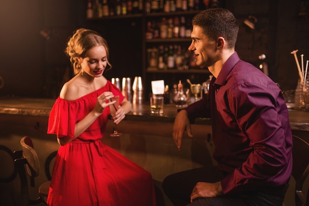 Woman in dress flirts with man in nightclub