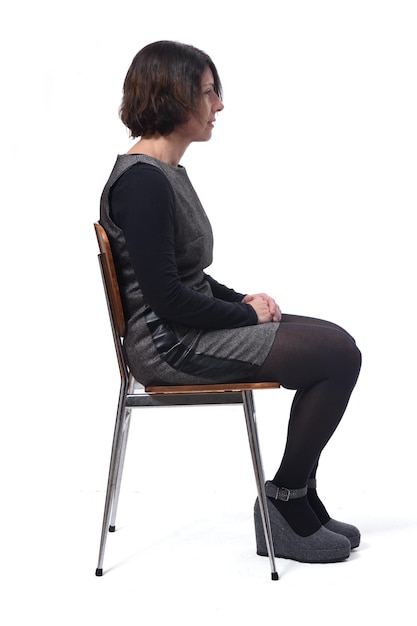 Woman in dress sitting on a white background