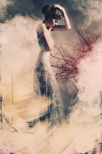 A woman in a dress. Smoke, atmossphere