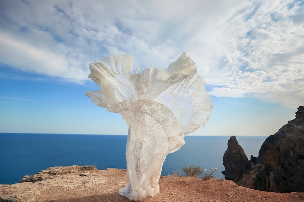 Woman in dress at the top of the mountain