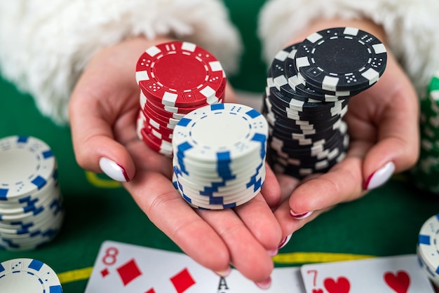 Woman in dress wins a game of blackjack and is happy with all the chips after playing poker