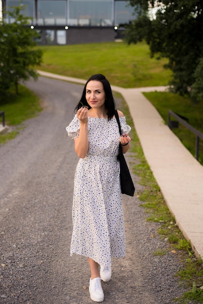 Woman in a dress with a black jacket on the back