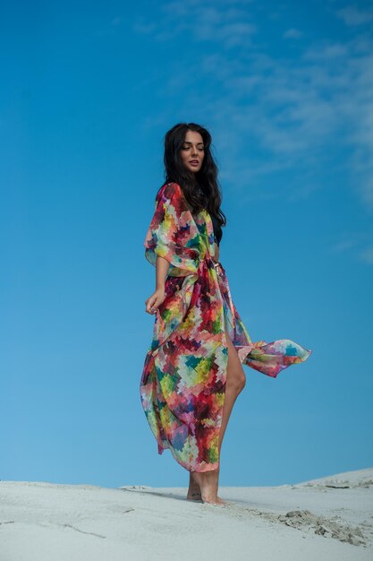 A woman in a dress with a blue sky behind her