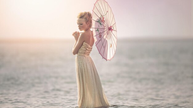 a woman in a dress with an umbrella in the foreground