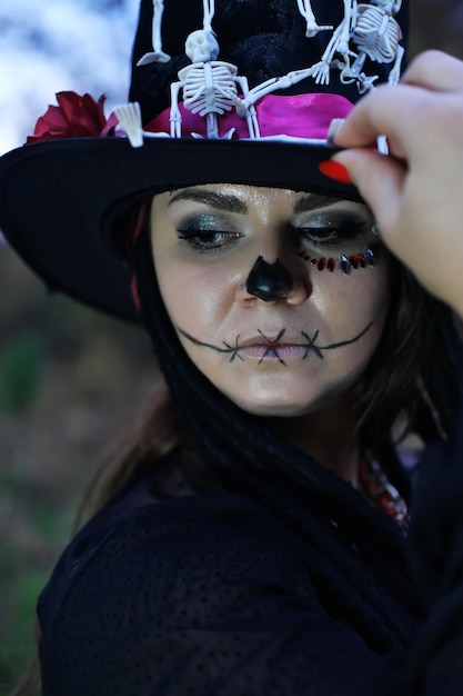 A woman dressed as Baron Saturday poses for the camera