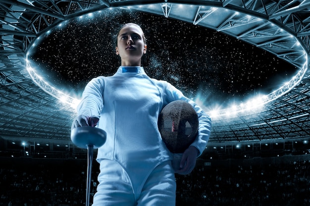 Woman dressed as a fencer posing with a mask and a sword