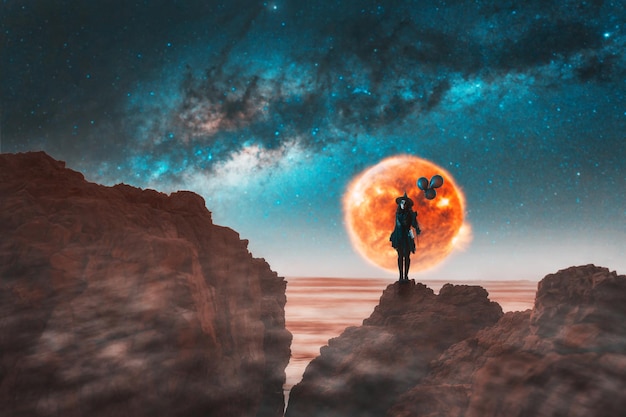 Woman dressed as a witch face painted holding black balloons on a cliff with the milky way in the background