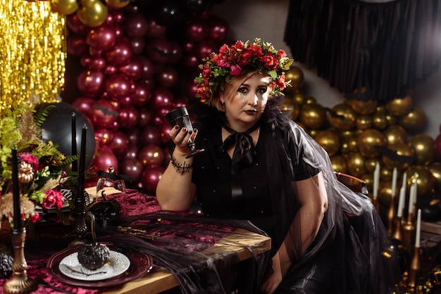 Woman dressed as a witch with flowers on her head