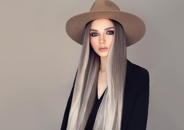 Woman dressed in a cowboy style hat Straight hair dyed in a pale gray shades with the blonde wisps